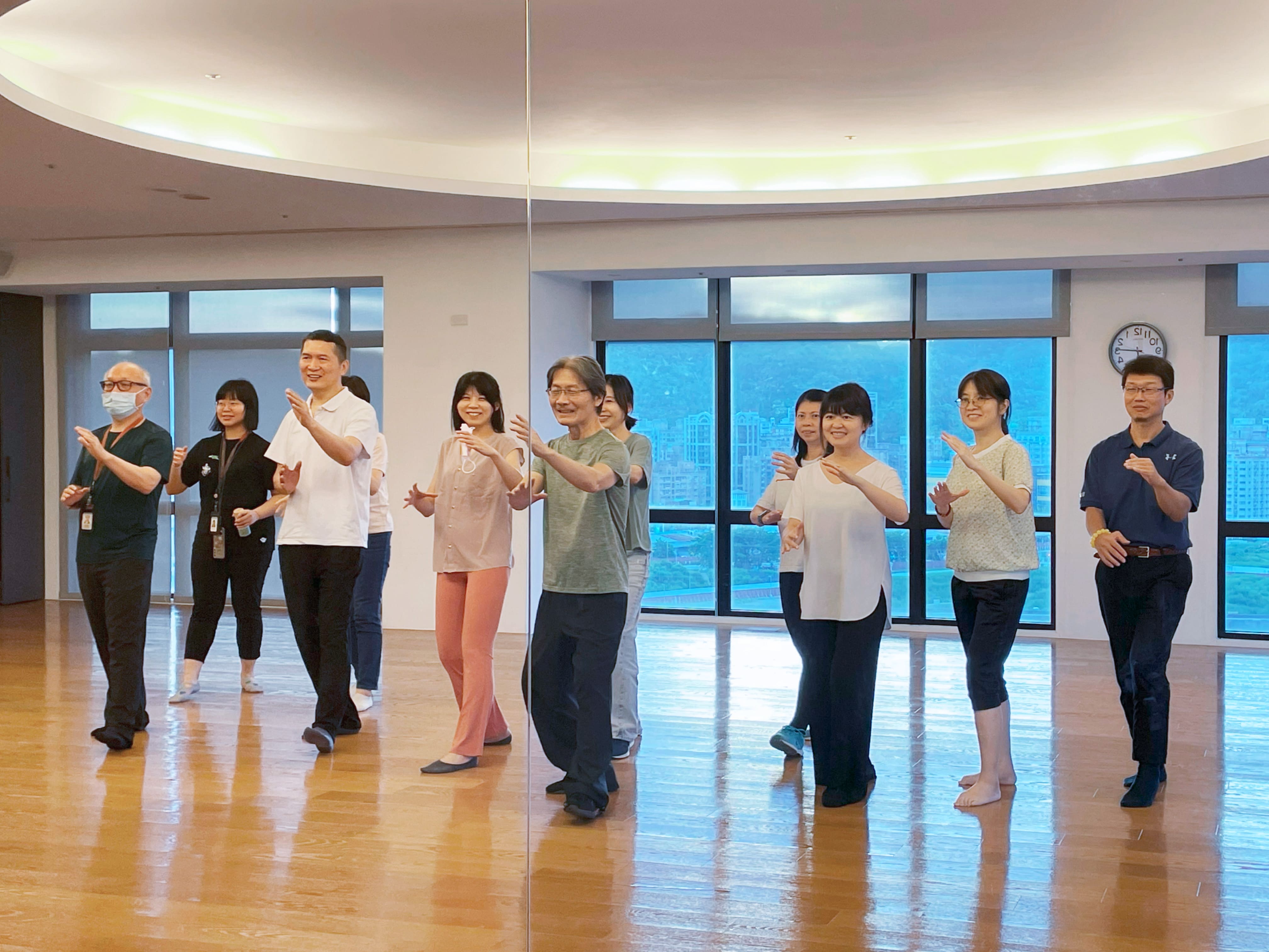 Ability employees pose for a photo in Tai Chi poses