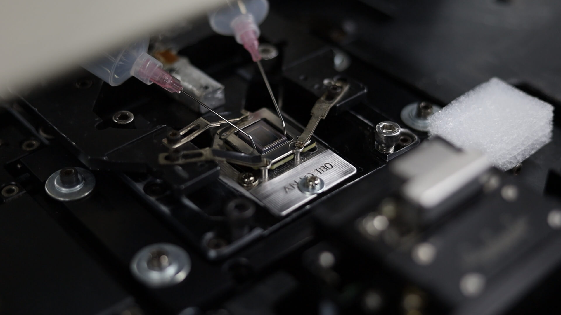 High-precision lens module undergoing active alignment process using UV and 6-axis calibration for superior resolution performance
